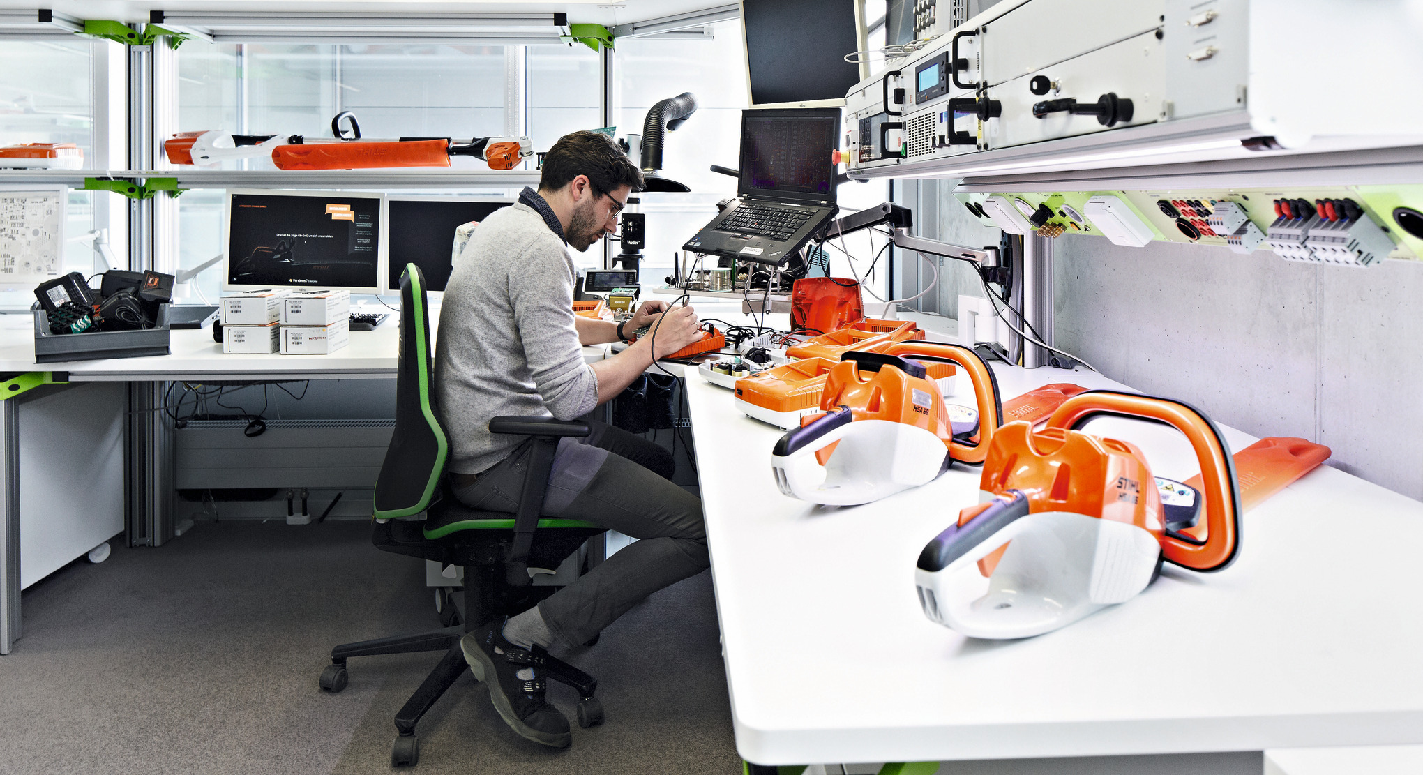 Person at a desk with STIHL tools in the front