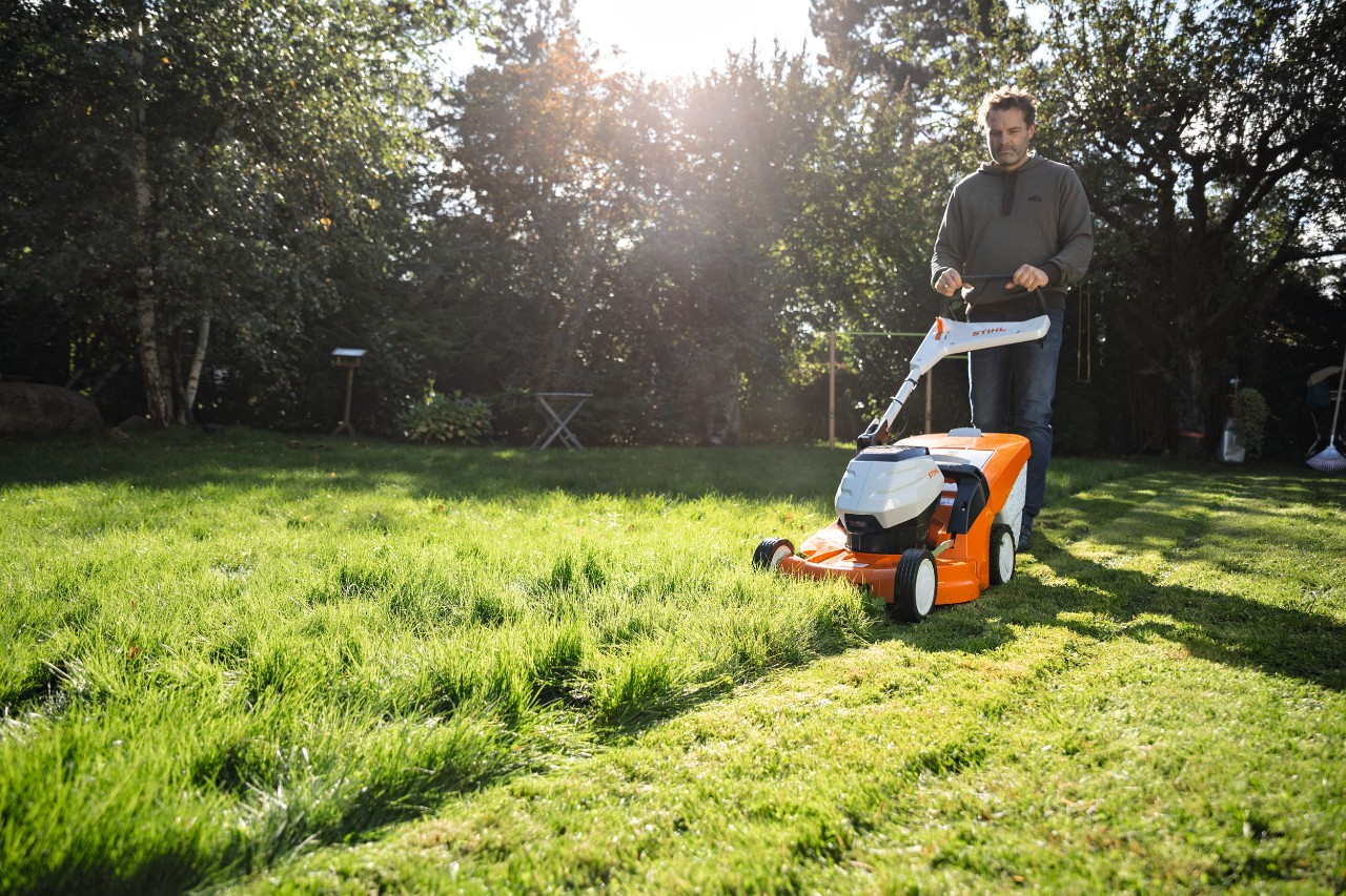 Image of man mowing a lawn  