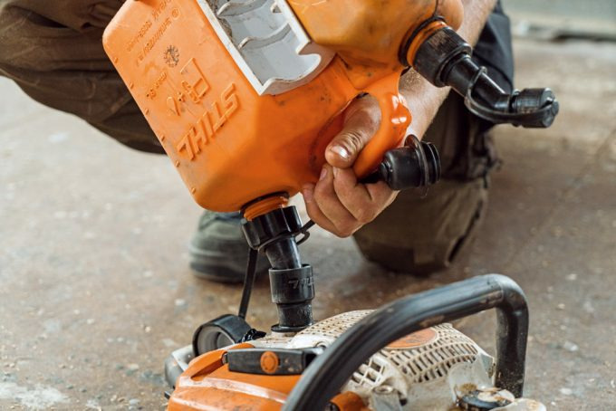 A person fills STIHL fuel E-10 into a canister